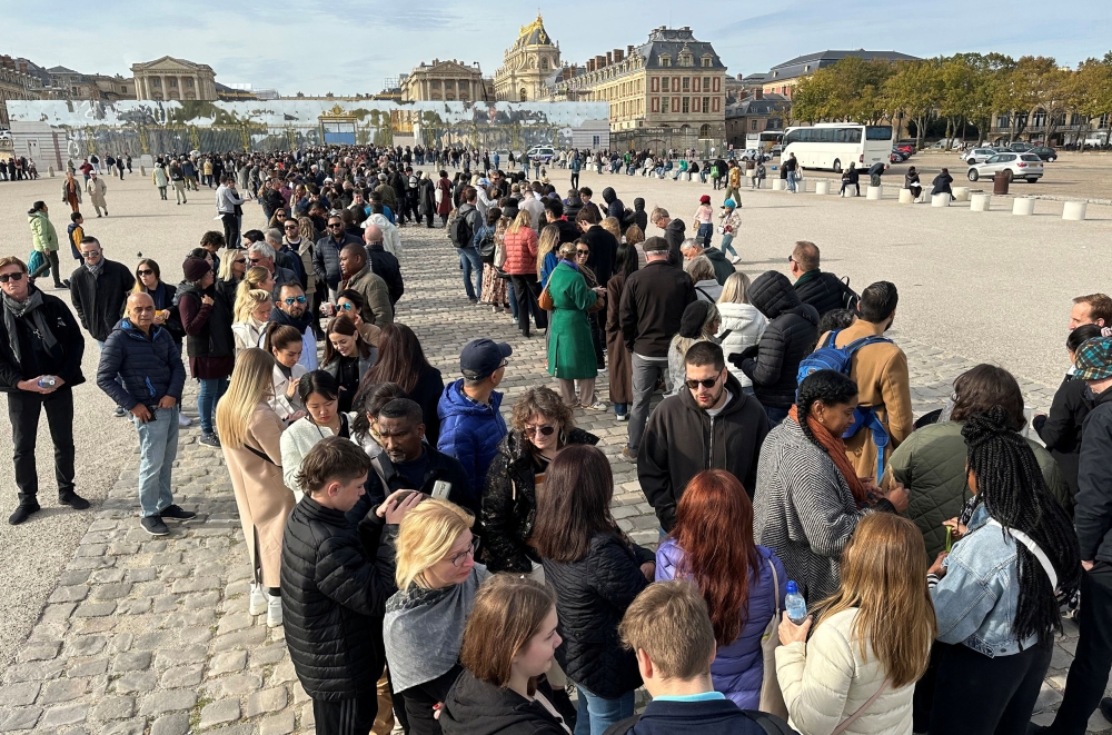 Tourists queue to enter the Chateau de Versailles after it was evacuated for security reasons. — Reuters pic