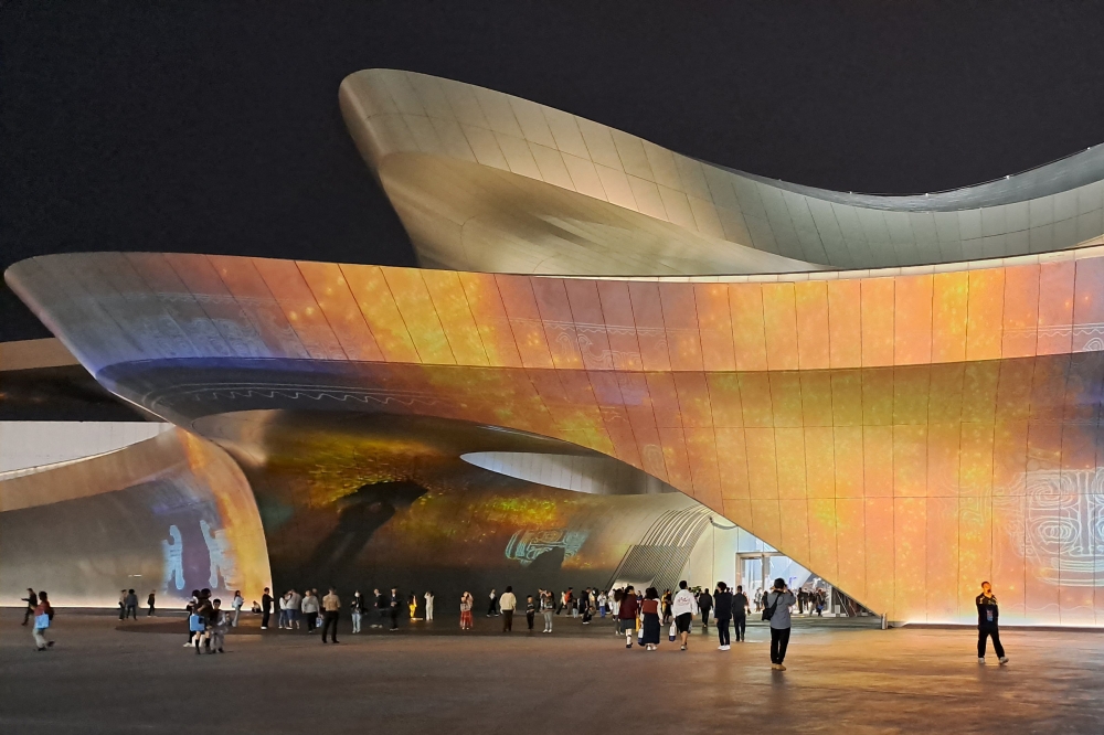 This photo taken on October 21, 2023 shows people walking outside the Chengdu Science Fiction Museum, designed by Zaha Hadid Architects, during WorldCon, the World Science Fiction Convention, in Chengdu. — AFP pic