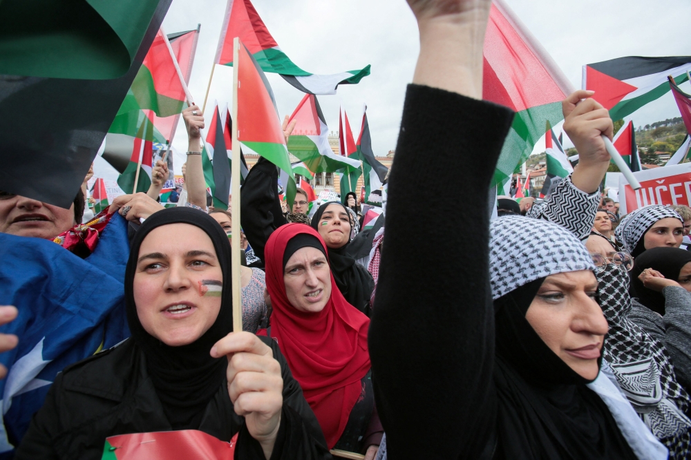 Bosnian people wave Palestinian flags during the rally in support of Palestinian people in the Gaza Strip and the West Bank, as the conflict between Israel and Hamas continues, in Sarajevo, Bosnia and Herzegovina, October 22, 2023. — Reuters pic