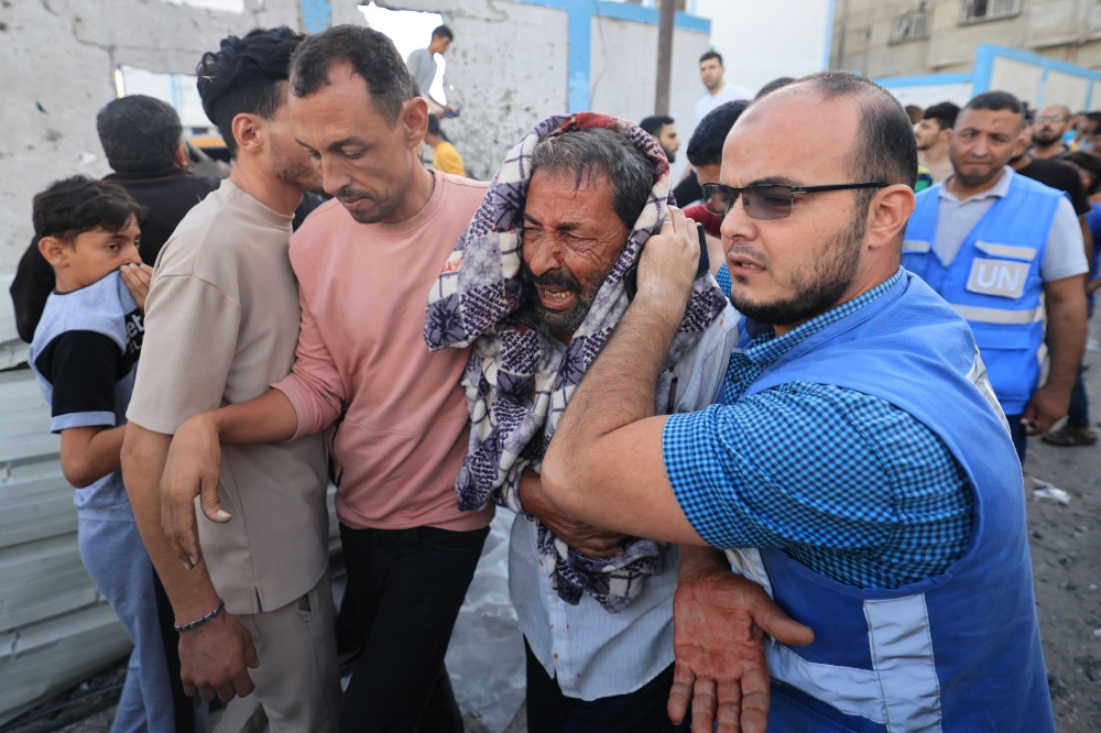 Palestinians evacuate a wounded man after an Israeli strike near an United Nations Relief and Works Agency for Palestine Refugees (UNRWA) school in Khan Yunis, in the southern Gaza Strip. — AFP pic