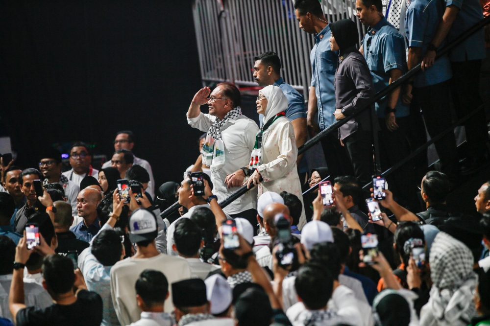 Prime Minister Datuk Seri Anwar Ibrahim salutes the crowd after delivering his speech during the Solidarity with Palestine rally at Axiata Arena, Bukit Jalil, October 24, 2023. — Picture by Hari Anggara 