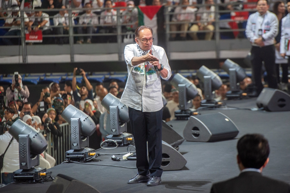 Prime Minister Datuk Seri Anwar Ibrahim speaks during the Palestine Rally held at Axiata Arena in Bukit Jalil last night. ― Picture by Shafwan Zaidon