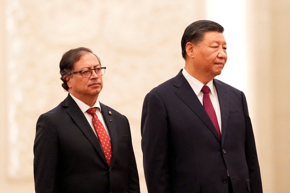 Colombian President Gustavo Petro inspects an honor guard with Chinese President Xi Jinping during a welcoming ceremony at the Great Hall of the People in Beijing, China, October 25, 2023. — Pool via Reuters pic