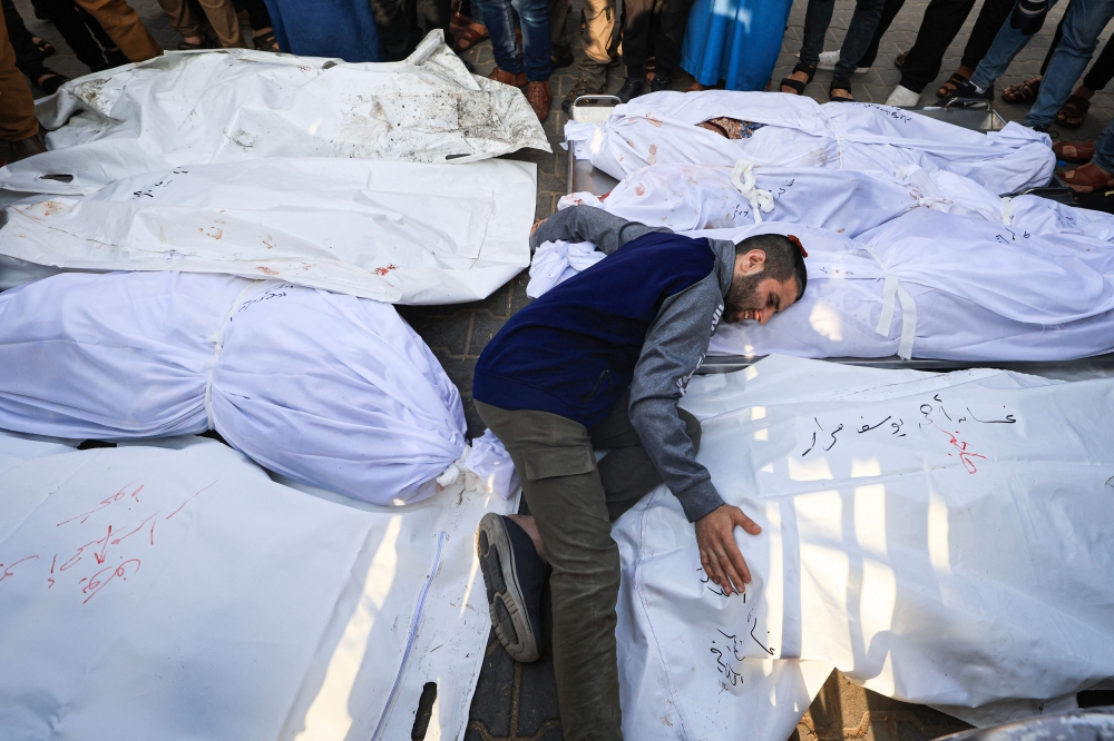 A man mourns the death of his family members following Israeli strikes in Khan Yunis. — AFP pic