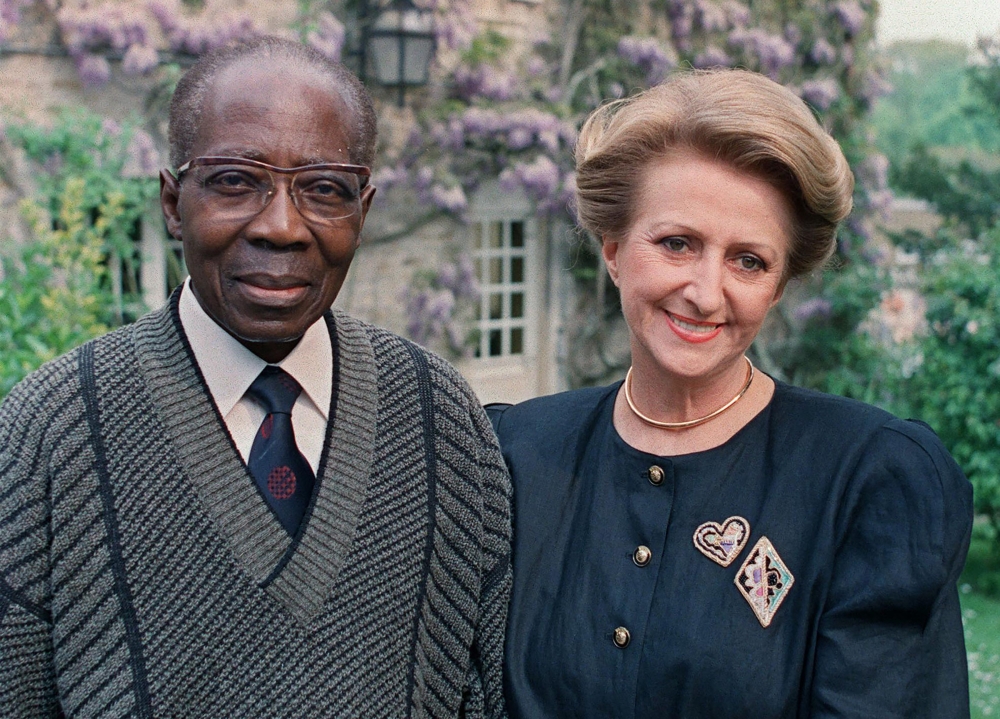 This file photograph taken on May 11, 1989, shows Leopold Sedar Senghor, the former president of Senegal with his wife Colette in their garden at Verson, north-western France. — AFP pic