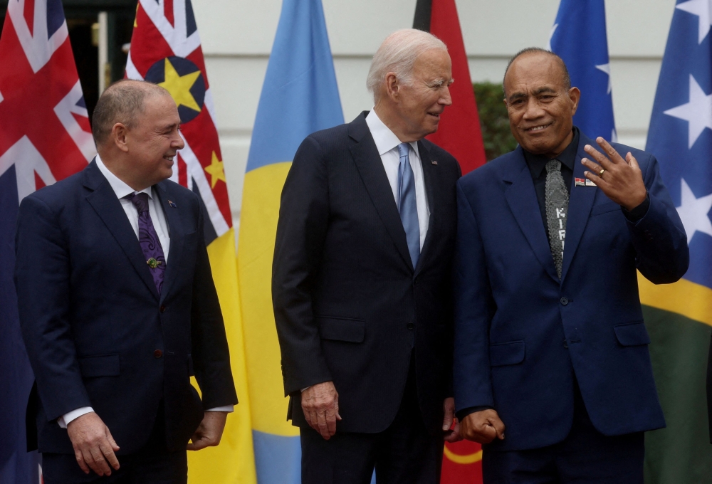 US President Joe Biden chats with President of Kiribati Taneti Maamau as Prime Minister of the Cook Islands Mark Brown stands next to them while Pacific Island nation leaders pose for a group photograph during a summit at the White House in Washington September 25, 2023. — Reuters pic