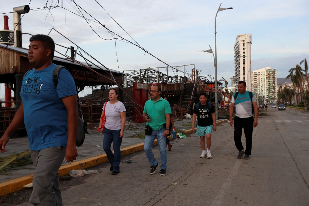 People walk on a street after Hurricane Otis hit, in Acapulco in the Mexican state of Guerrero, Mexico October 26, 2023. — Reuters pic