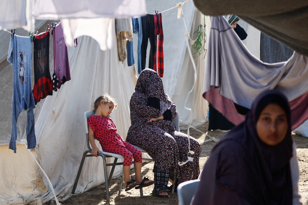 Palestinians, who fled their houses amid Israeli strikes, take shelter at a tent camp at a United Nations-run centre, after Israel's call for more than 1 million civilians in northern Gaza to move south, in Khan Younis in the southern Gaza Strip, October 26, 2023. — Reuters pic