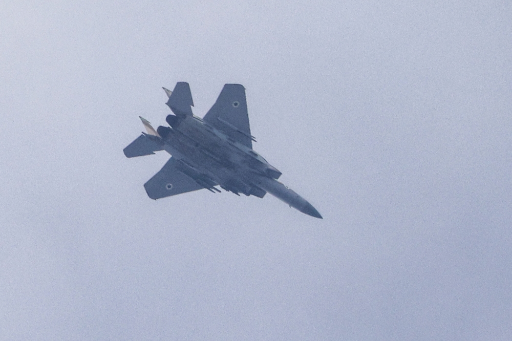 An Israeli air force F-15 fighter tactical fighter aircraft flies along the border with the Gaza Strip near Sderot in southern Israel on October 27, 2023 amid ongoing battles between Israel and the Palestinian Hamas movement. — AFP pic
