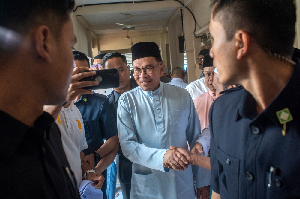 Prime Minister Datuk Seri Anwar Ibrahim greets the public after Friday prayers at Masjid As-Shariff, Jalan Anggerik, Kampung Dato' Ahmad Razali, Dengkil October 27, 2023. — Picture by Shafwan Zaidon