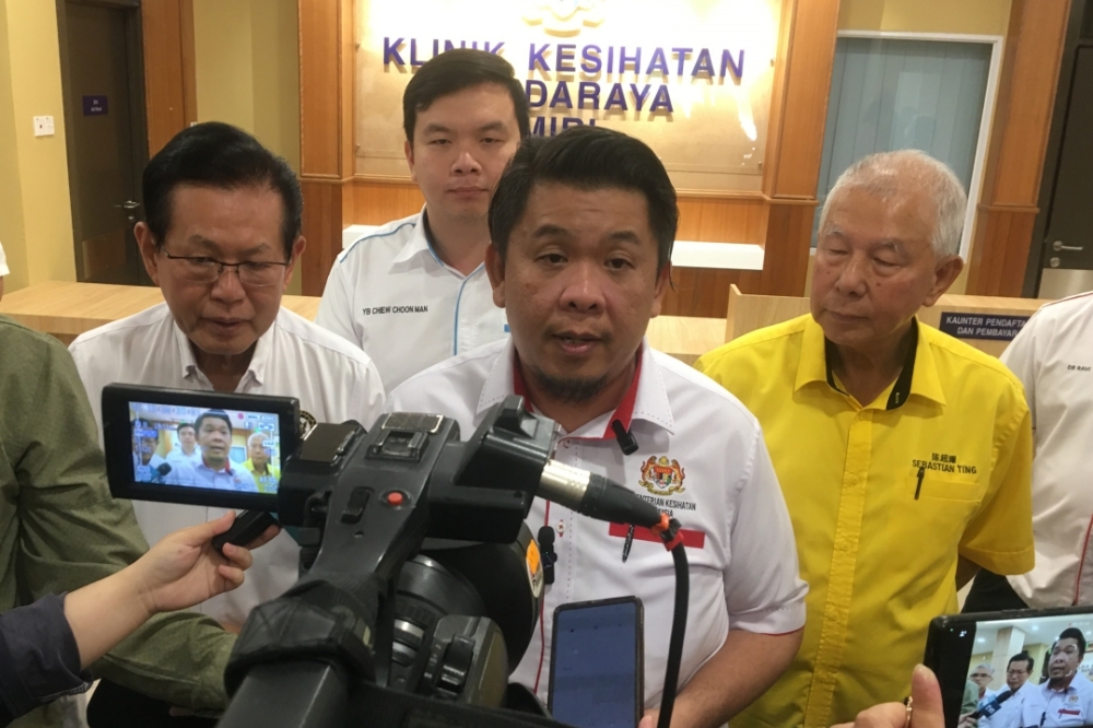 Lukanisman speaking to reporters after witnessing the symbolic handing-over of the new Miri City Health Clinic. Behind him are (from left) Lee, Chiew and Ting. — Borneo Post Online pic