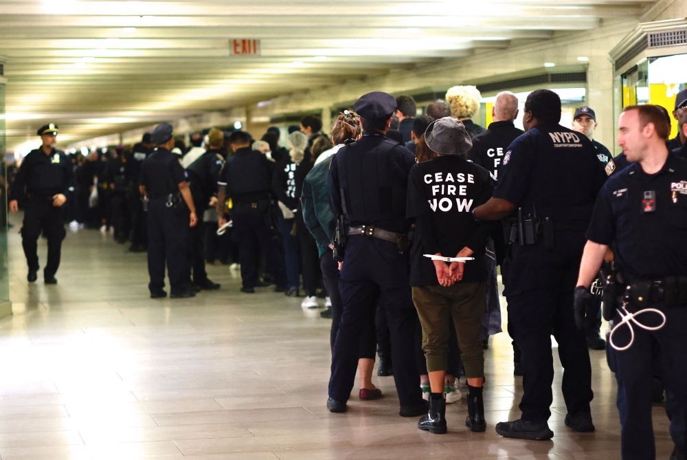 NYPD officers arrest protesters during a demonstration calling for a ceasefire amid war between Israel and Hamas, at Grand Central Station in New York October 27, 2023. ― AFP pic