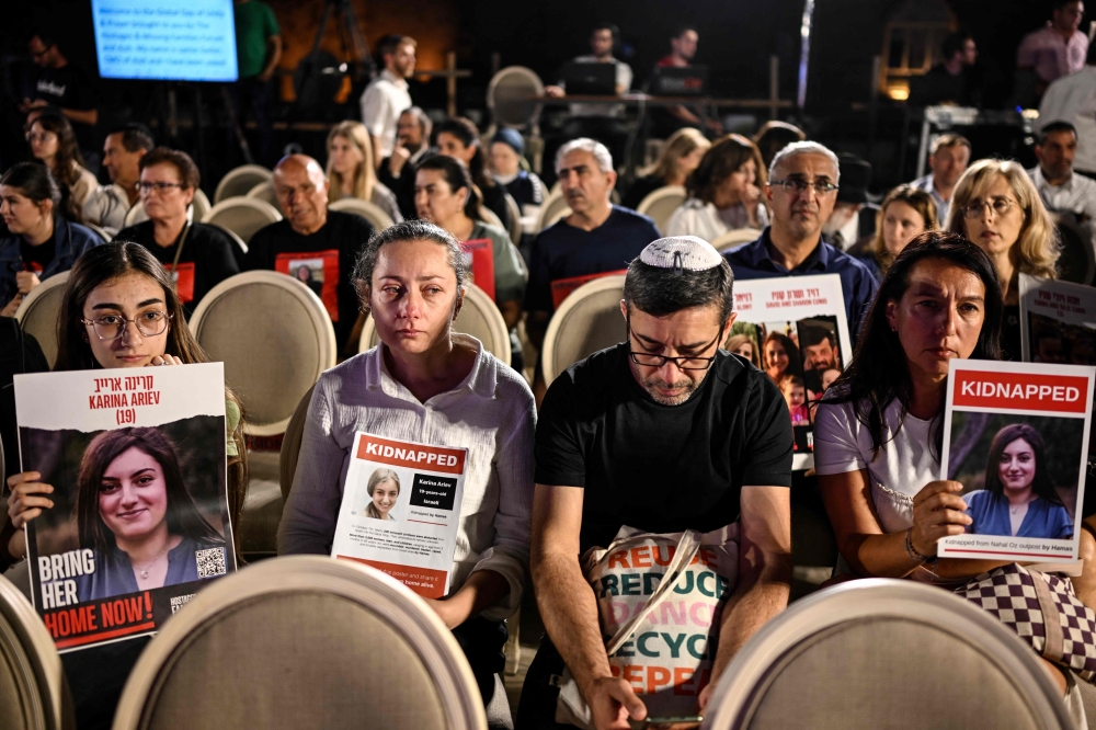 People gather at a spot overlooking the Western Wall plaza as they attend the Global Day of Unity and Prayer with Israel’s Hostages and Missing Families Forum, which represents the relatives of those taken captive by Palestinian Hamas militants during the October 7 attack, in Jerusalem on October 25, 2023. — AFP pic