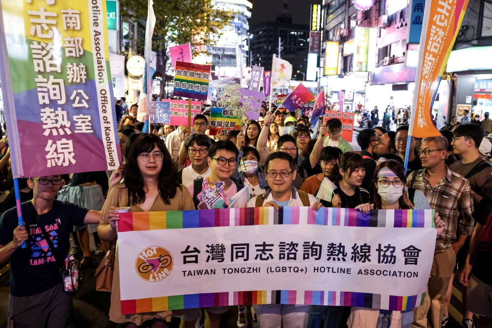 Activists rainbow banners during the annual Taiwan Trans March, along a street in Taipei on October 27, 2023. — AFP pic