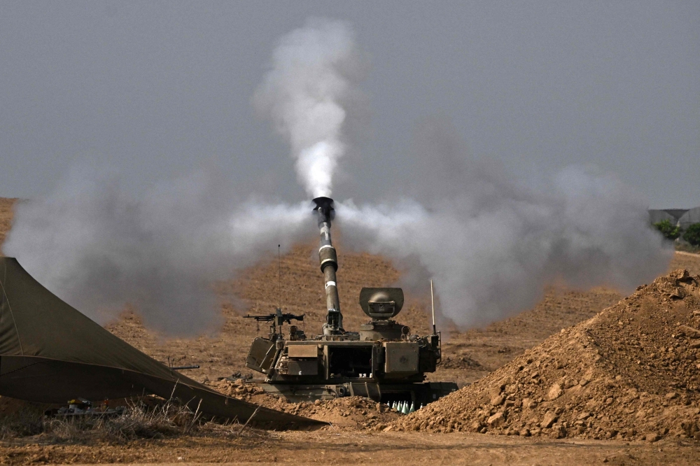 The Israeli military fires mortar shells toward the Gaza Strip on October 28, 2023. — AFP pic
