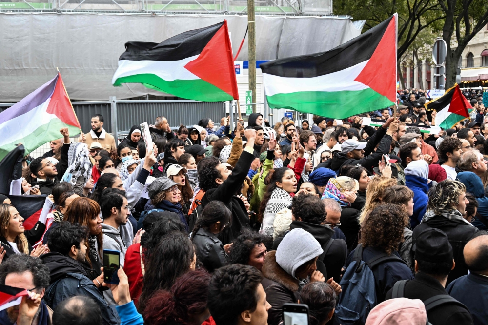 Protesters wave Palestinian flags during a demonstration in support to Palestinans, at the Place du Chatelet in central Paris on October 28, 2023. — AFP pic