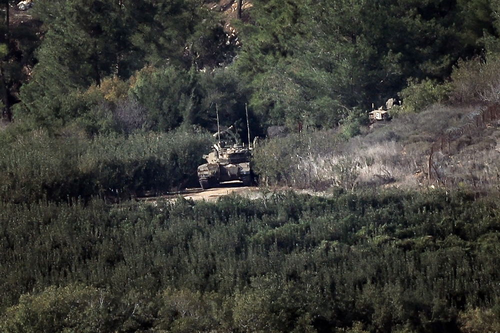 An Israeli tank advances on a road in northern Israel near the border with Lebanon on October 28, 2023, amid intensifying cross-border skirmishes. — AFP pic