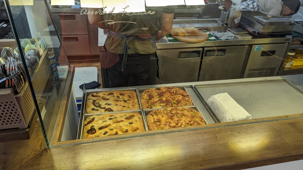 Loaves of freshly baked focaccia on display.