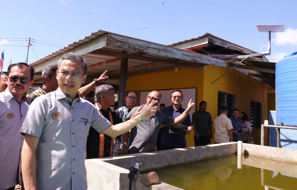 Communications and Digital Minister Fahmi Fadzil visiting the Starlink satellite device installation site in Kampung Langsat, Ranau October 29, 2023. — Bernama pic