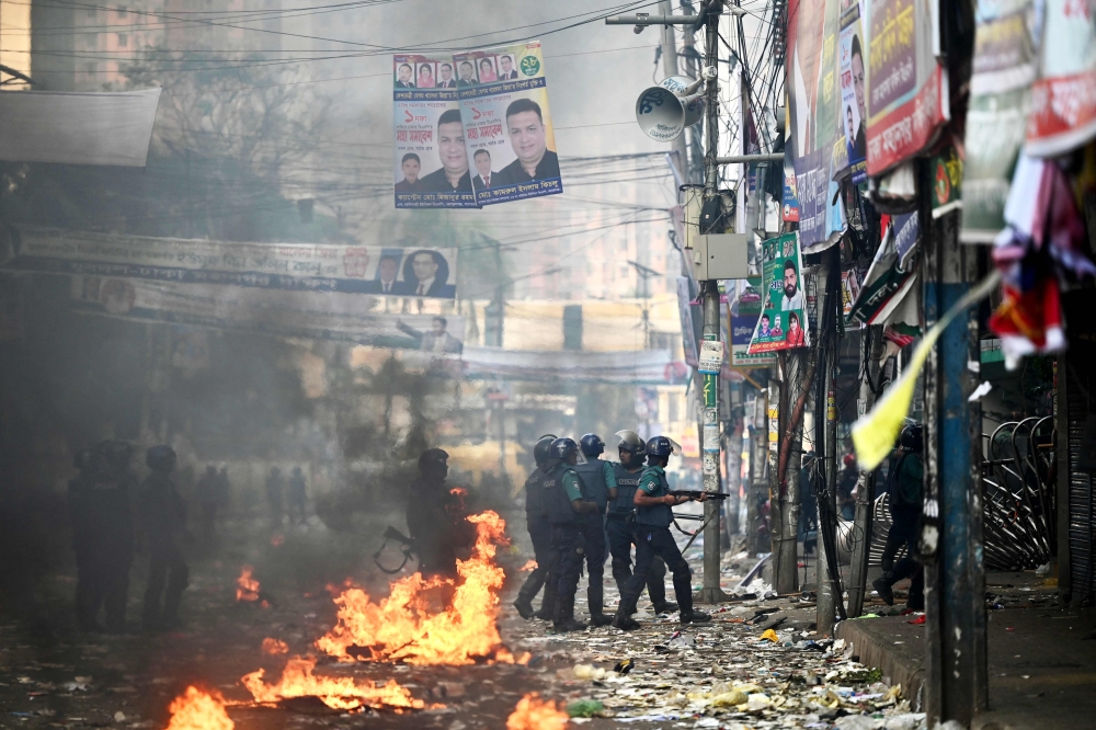 Police stand guard during a rally by the Bangladesh Nationalist party (BNP) supporters demanding for the resignation of Prime Minister Sheikh Hasina in Dhaka on October 28, 2023. — AFP pic