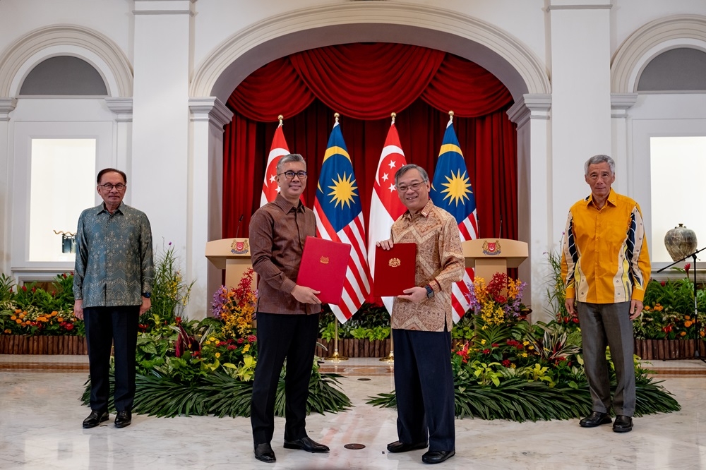(From left) Malaysia's Prime Minister Datuk Seri Anwar Ibrahim,  Minister of Investment, Trade and Industry Datuk Seri Tengku Zafrul Abdul Aziz, Singapore’s Minister of Trade and Industry Gan Kim Yong and Singapore's Prime Minister Lee Hsien Loong are seen during the signing of a ‘side letter’ to improve the provisions of the Malaysia-Singapore Business Development Fund agreement for third countries. — Picture by Afiq Hambali/Prime Minister’s Office of Malaysia 
