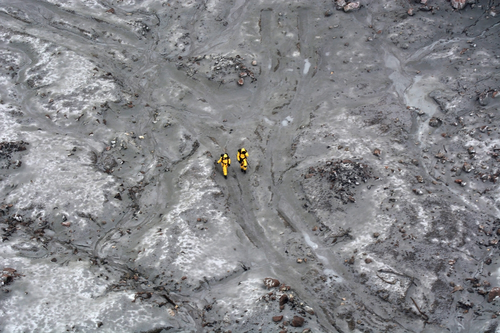 This handout aerial photo taken and released on December 13, 2019 by the New Zealand Defence Force shows elite soldiers taking part in a mission to retrieve bodies from White Island after the December 9 volcanic eruption. — AFP pic/New Zealand Defence Force