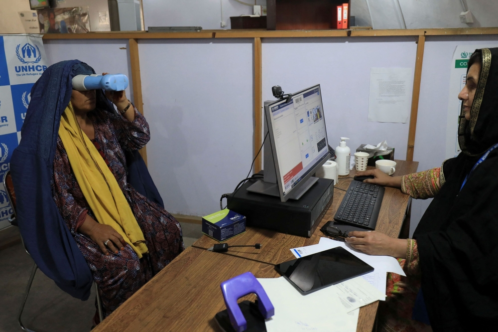 An Afghan refugee woman gets her IRIS test as she along with others is returning home, after Pakistan gives the last warning to undocumented immigrants to leave, at the United Nations High Commissioner for Refugees (UNHCR) repatriation centres in Azakhel town in Nowshera, Pakistan October 30, 2023. — Reuters pic