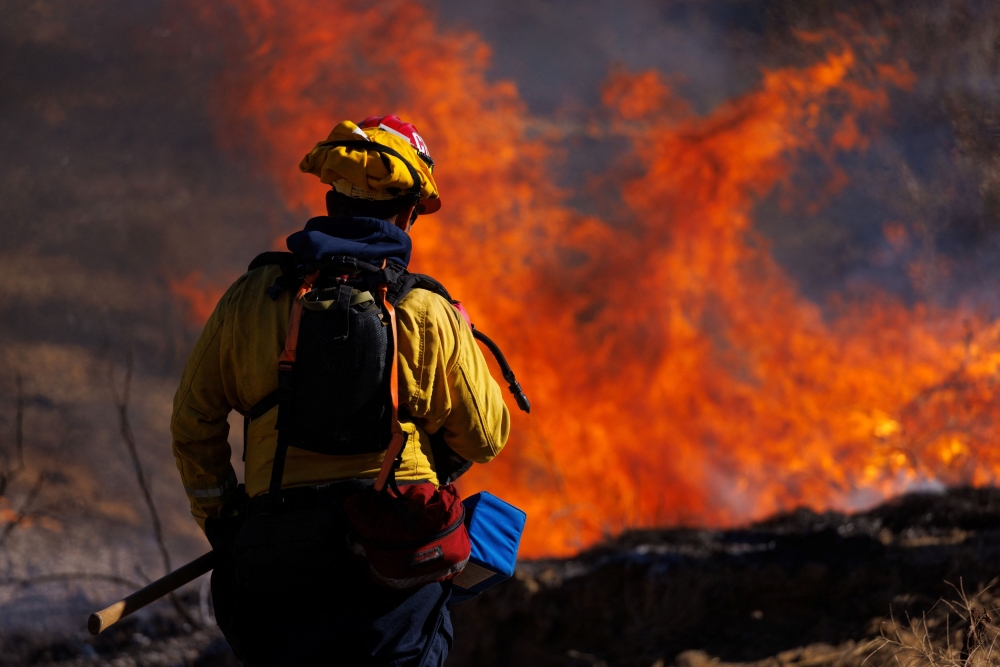 Firefighters battle the Highland Fire, a wind — driven wildfire near Aguanga, California October 31, 2023. ¬— Reuters pic