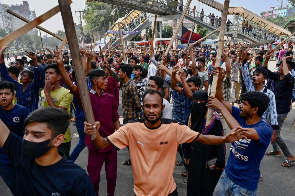 Garment workers block roads as they take part in a protest in Dhaka on November 1, 2023. — AFP pic