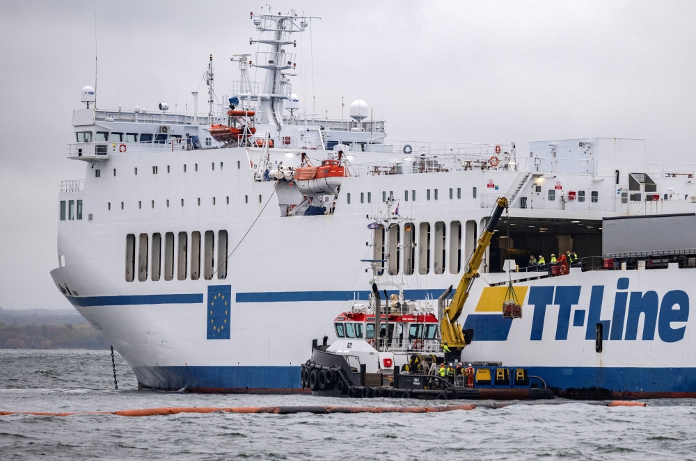 View of the grounded TT Line Marco Polo ferry and a tug boat, as the ferry leaks oil into the Baltic off the coast of Horvik, Sweden October 26, 2023. — TT News Agency/Johan Nilsson via Reuters pic