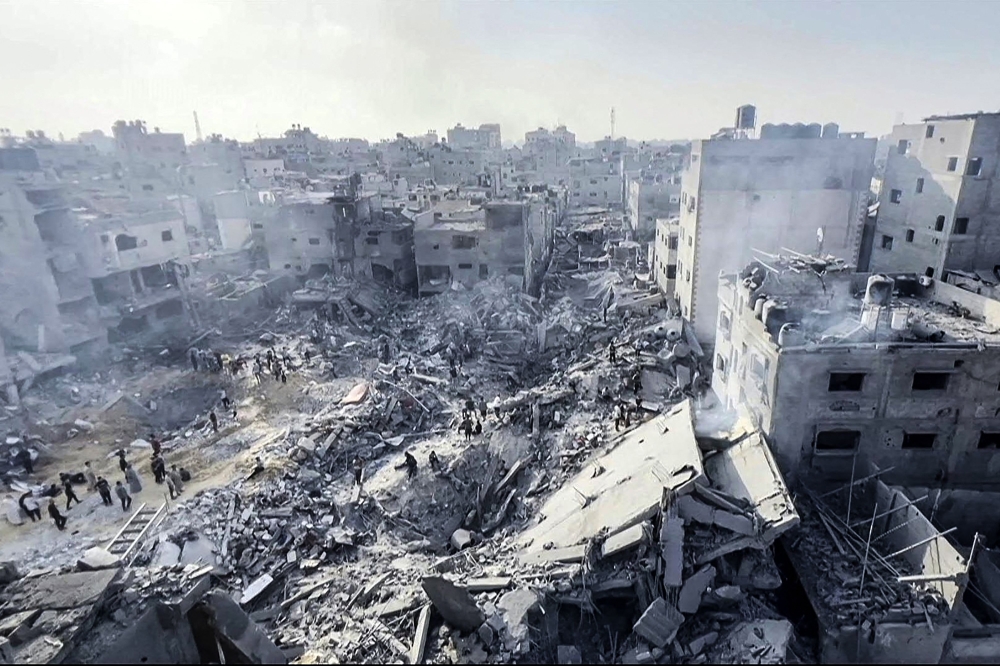 This image grab taken from AFPTV video footage shows Palestinians checking the destruction in the aftermath of an Israeli strike on the Jabalia refugee camp in the Gaza Strip, on November 1, 2023, amid ongoing battles between Israel and the Palestinian Hamas movement. — AFP pic