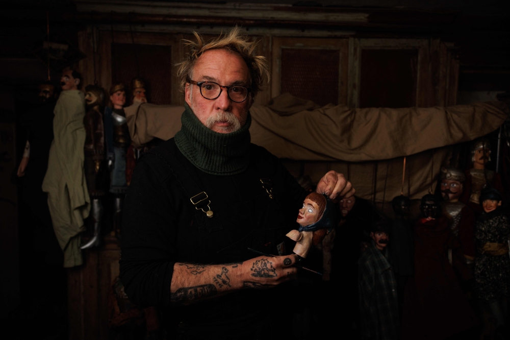 Belgium actor Bouli Lanners restores a puppet at his puppets workshop in Liege. — AFP pic