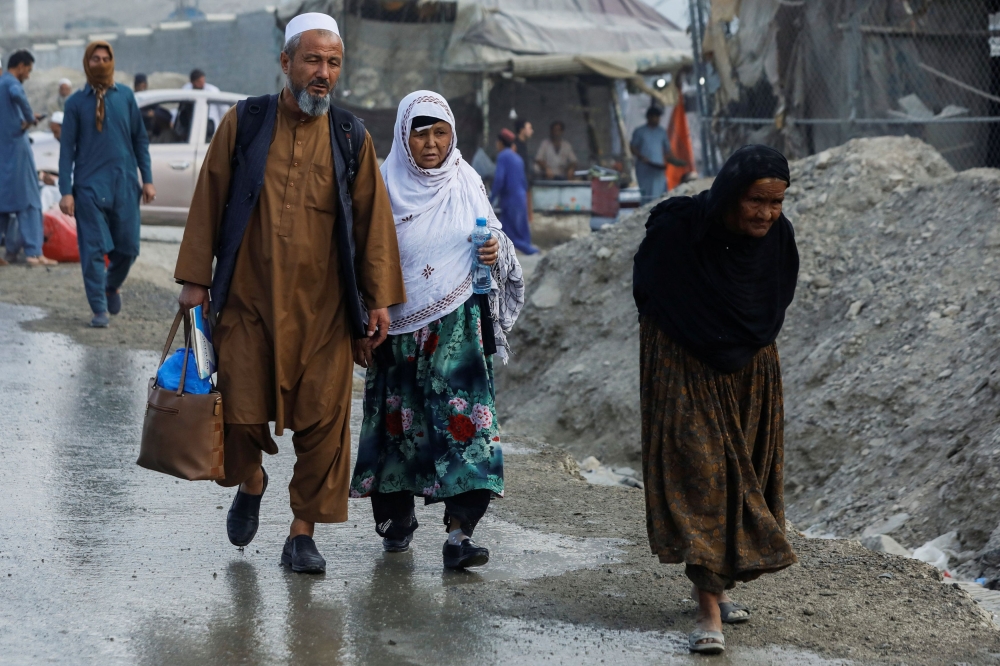 Afghan nationals walk as they head back to Afghanistan, after Pakistan gives last warning to undocumented immigrants to leave, at the Torkham border crossing between Pakistan and Afghanistan, November 2, 2023. — Reuters pic