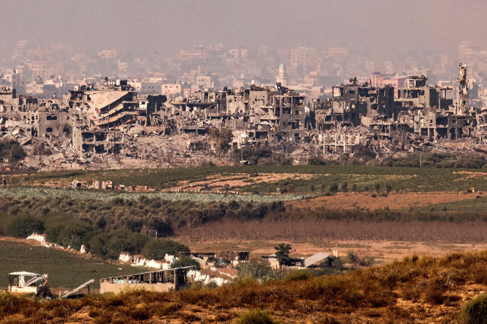This picture taken on November 3, 2023 from a position along the border with the Gaza Strip in southern Israel shows buildings destroyed by Israeli bombardment on the backdrop of the Gaza skyline amid ongoing battles between Israel and the Palestinian Hamas movement. The UAE warned today that there was a risk of a regional spillover from the Israel-Hamas war in Gaza. — AFP pic