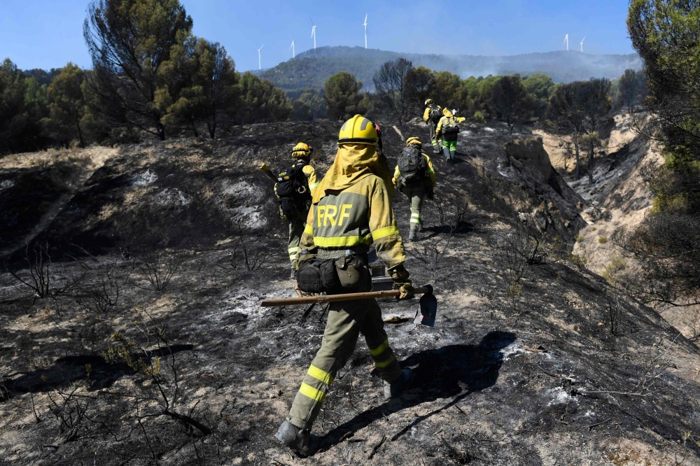 File photo of members of the Forest Fires Reinforcement Brigades working to put out a wildfire in the Moncayo Natural Park, near the village of Borja, in the northern region of Aragon on August 15, 2022. Spanish authorities have evacuated at least 800 people around Gandia in the eastern region of Valencia after a wildfire broke out there. — AFP pic