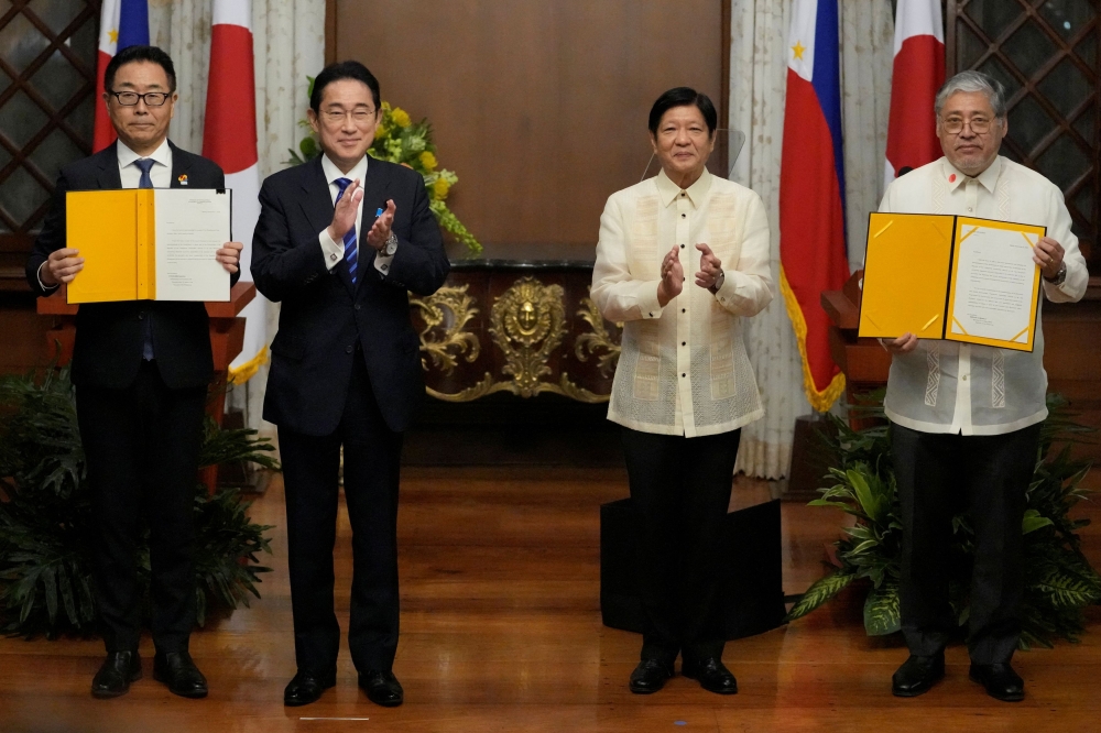 Japan Prime Minister Fumio Kishida and Philippine President Ferdinand ‘Bongbong’ Marcos Jr applaud after the exchange of documents at Malacanang Palace in Manila November 3, 2023. — Aaron Favila/Pool/Reuters pic