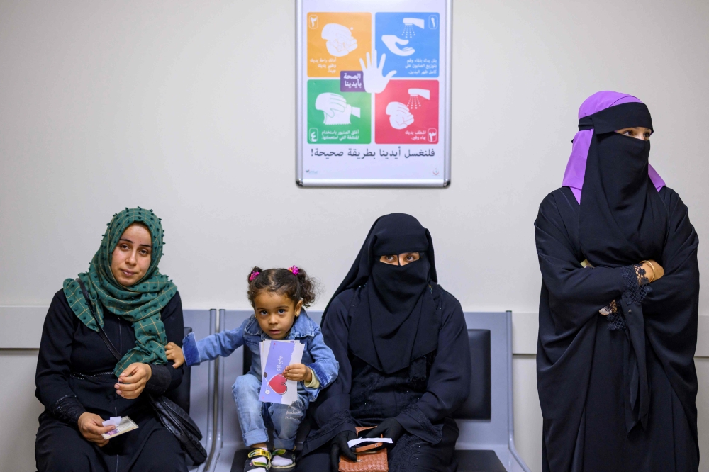 Syrian refugees wait in line at the Makam Extended Migrant Health Center in Sanliurfa, southeastern Turkey, on October 17, 2023. — AFP pic