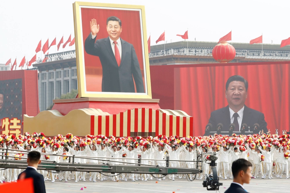 File photo of performers travelling past Tiananmen Square with a float showing Chinese President Xi Jinping during the parade marking the 70th founding anniversary of People's Republic of China, on its National Day in Beijing, China October 1, 2019. — Reuters pic