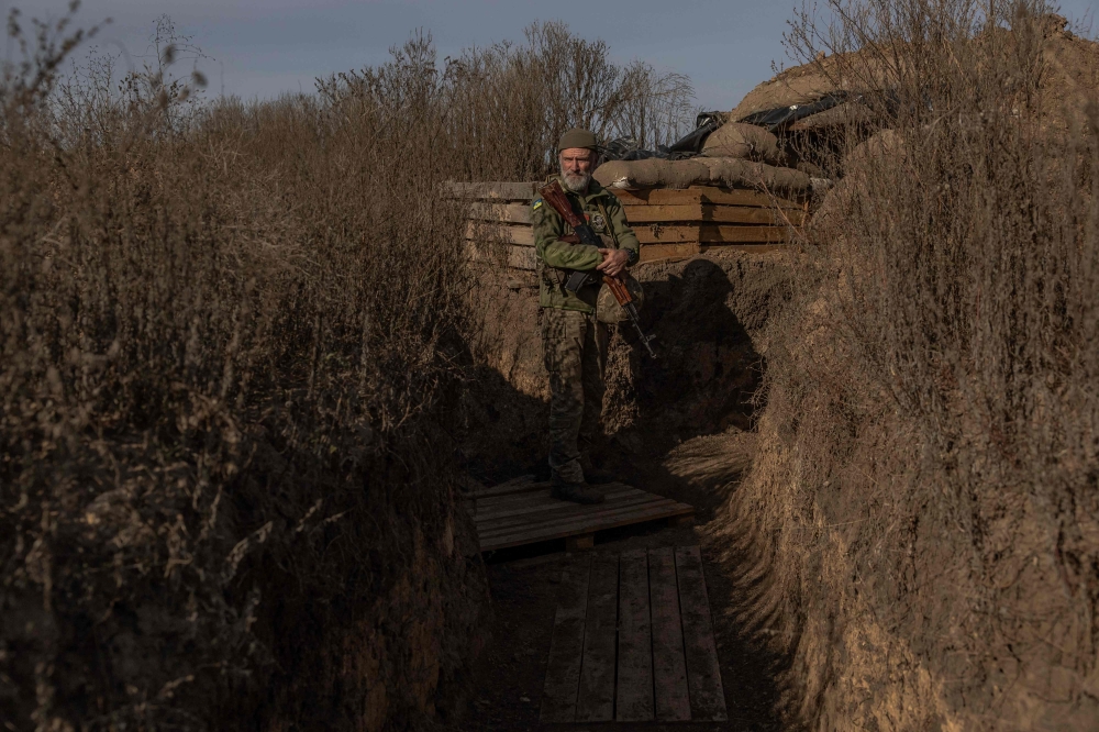 A Ukrainian serviceman stands guard at a position outside the southern city of Kherson, on November 2, 2023, amid Russia’s military invasion on Ukraine. Ukraine's most senior military official said that the nearly two-year conflict with Russia had reached a stalemate, with Russia rejecting the comments. — AFP pic