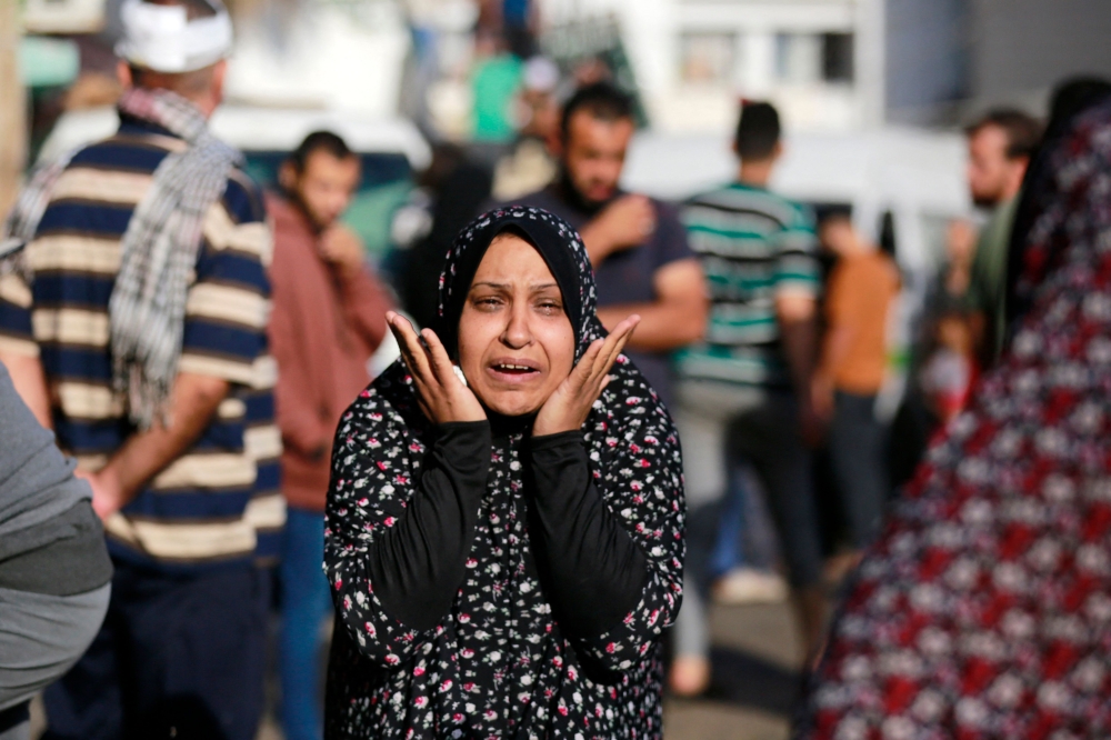 The relative of a victim killed a day earlier in an Israeli strike that hit the entrance of Al-Shifa hospital in Gaza City, reacts during a funeral held for the victims on November 4, 2023. — AFP pic