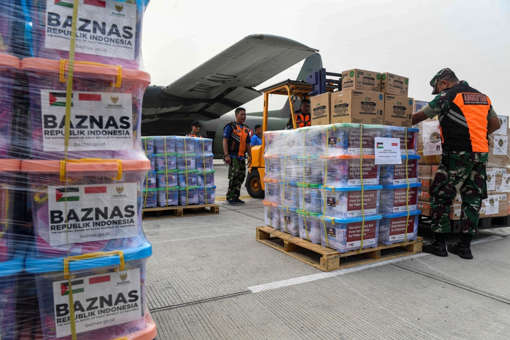 Indonesian soldiers prepare the aid supplies for Palestinians in Gaza, before its departure at Halim Perdanakusuma airbase in Jakarta, Indonesia, November 4, 2023, in this photo taken by Antara Foto. — Reuters pic