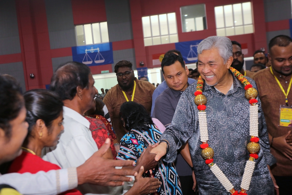 Deputy Prime Minister Datuk Seri Ahmad Zahid Hamidi greets attendees at a Deepavali function at the Bagan Datuk Umno Complex November 4, 2023. — Bernama pic