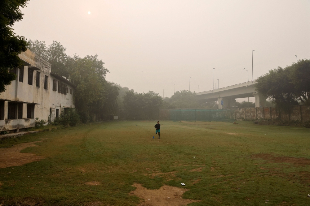 A man exercises on a playground of the school after primary classes were ordered shut by the Delhi government for Friday and Saturday as the air pollution increased and the air quality index (AQI) plummeted, on a smoggy morning in New Delhi, India, November 3, 2023. — Reuters pic