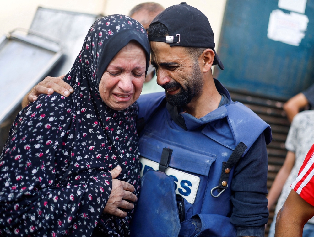 Anadolu news agency cameraman Mohammed El Aloul reacts after several of his children and siblings were killed in Israeli strikes, amid the ongoing conflict between Israel and Palestinian Islamist group Hamas, at a hospital in the central Gaza Strip, November 5, 2023. — Reuters pic