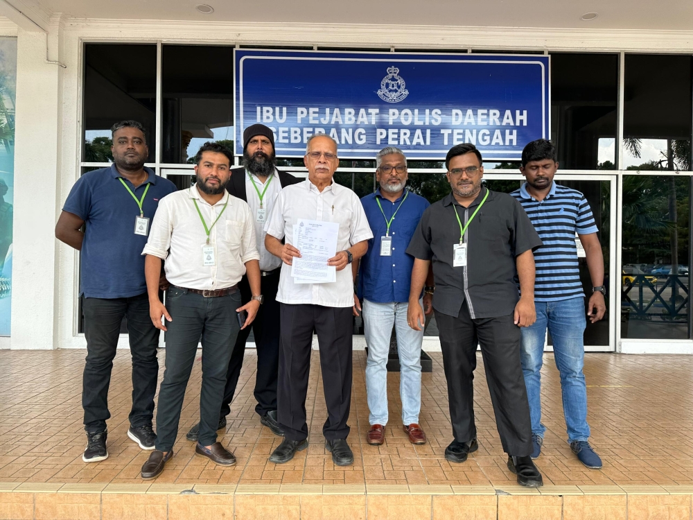 P. Ramasamy (4th from left) showing a copy of his police report against Dr Zakir Naik outside the Bukit Mertajam police station in Penang November 6, 2023 — Picture courtesy of P. Ramasamy
