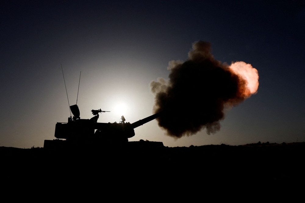 An Israeli military unit fires from an undisclosed location near the Gaza Strip border, amid the ongoing conflict between Israel and Palestinian Islamist group Hamas, in Israel November 6, 2023. ― Reuters pic