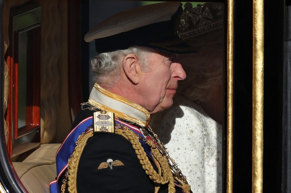 Britain’s King Charles III and Britain’s Queen Camilla travel in the Diamond Jubilee State Coach as he leaves Buckingham Palace in London on November 7, 2023, for the Houses of Parliament, for the State Opening of Parliament ceremony. — AFP pic