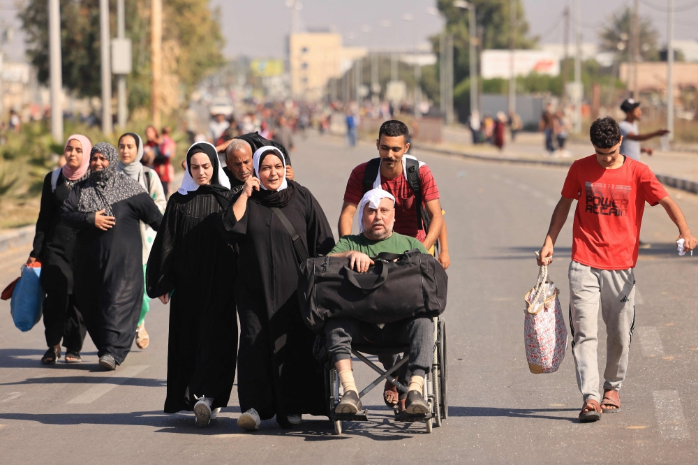  Palestinians fleeing Gaza City towards the southern areas walk on a road on November 7, 2023, amid the ongoing battles between Israel and the Palestinian Islamist group Hamas. — AFP pic