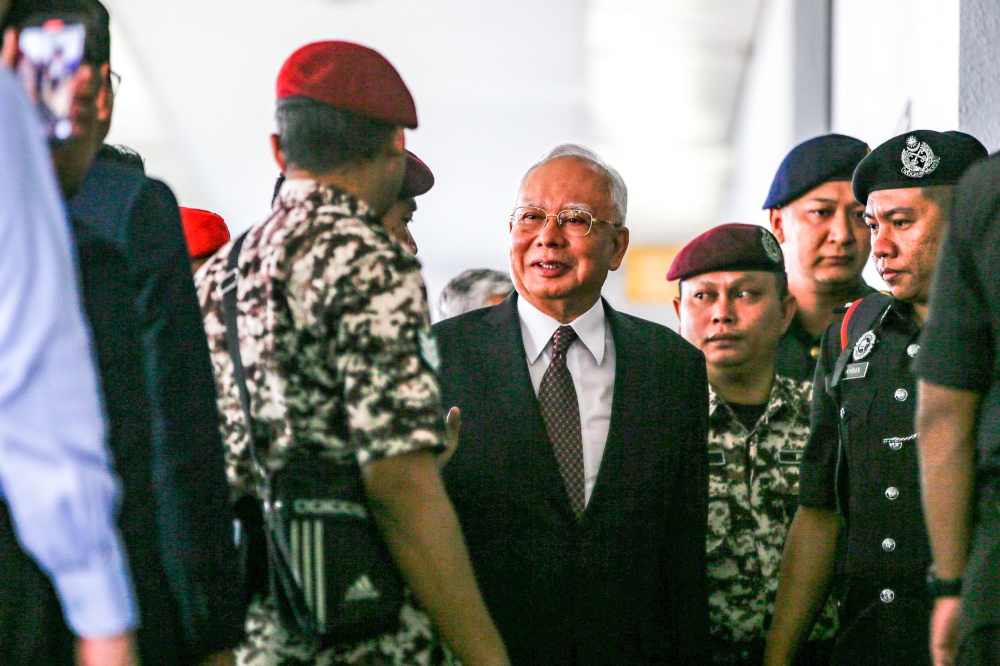 Datuk Seri Najib Razak escorted by Prisons Department personnel at the Kuala Lumpur High Court Complex, November 8, 2023. — Picture by Hari anggara.