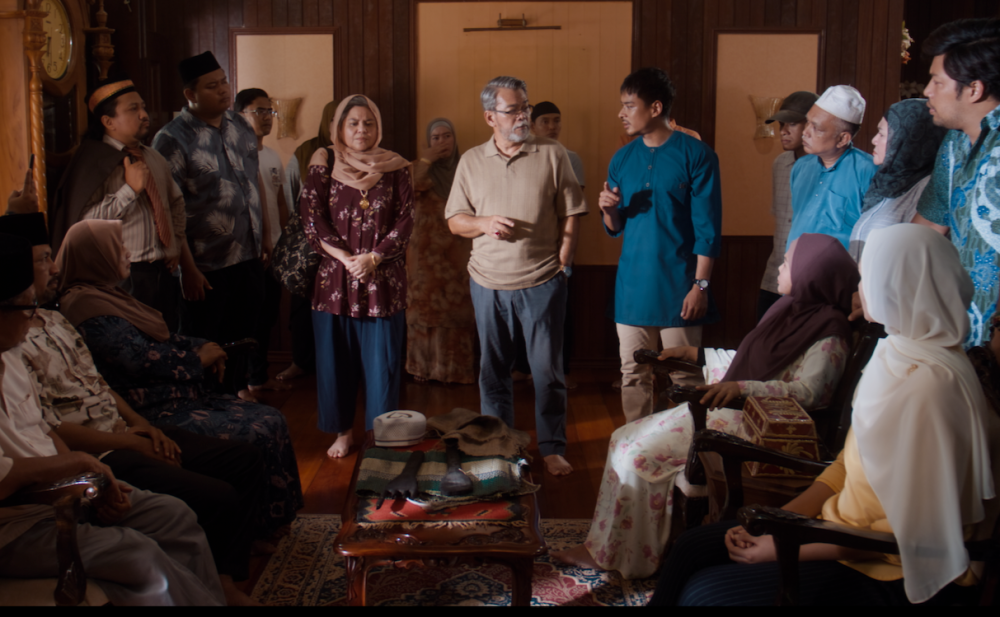 IB Yunus Ismail played by Gambit Saifullah (third from right of trio centre of the room) and the villagers of Kampung Sungai Gelik Kiri. — Picture courtesy of Mystic Village